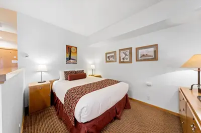 a hotel room with a bed and two lamps at Palisades Tahoe Lodge Rentals Studio #115 in Olympic Valley