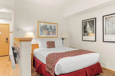 a bedroom with a large bed in a hotel room at Palisades Tahoe Lodge Rentals Studio #118 in Olympic Valley