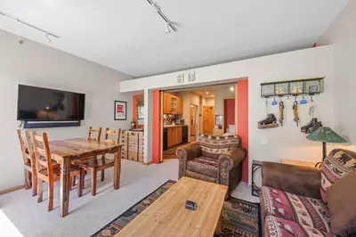 a living room with a table and a dining room at Palisades Tahoe Lodge Rentals Studio #151 in Olympic Valley