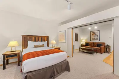 a bedroom with a large bed and a couch at Palisades Tahoe Lodge Rentals Studio #152 in Olympic Valley