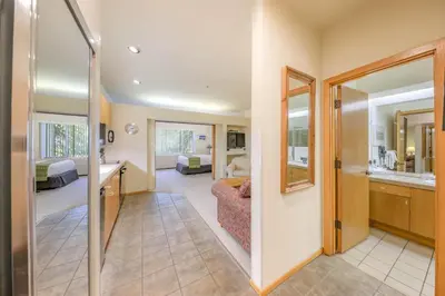 a room with a living room and a bedroom at Palisades Tahoe Lodge Rentals Studio #148 in Olympic Valley