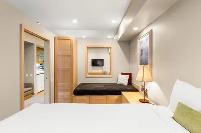 a bedroom with a bed and a tv in it at Palisades Tahoe Lodge Rentals Studio #211 in Olympic Valley