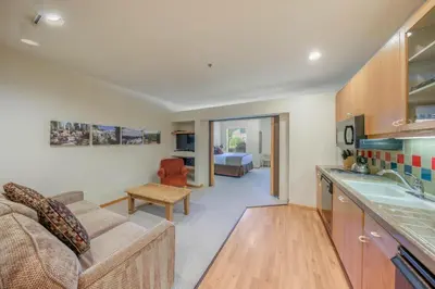 a kitchen and living room with a couch and a table at Palisades Tahoe Lodge Rentals Studio #158 in Olympic Valley