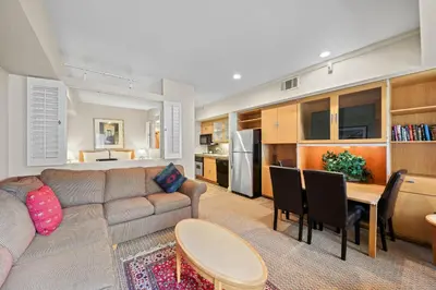 a living room with a couch and a dining room at Palisades Tahoe Lodge Rentals Studio #217 in Olympic Valley