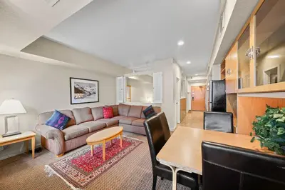 a living room with a couch and a table at Palisades Tahoe Lodge Rentals Studio #217 in Olympic Valley