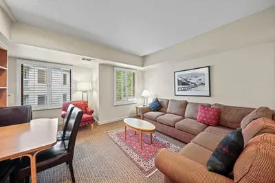 a living room with a couch and a table at Palisades Tahoe Lodge Rentals Studio #217 in Olympic Valley