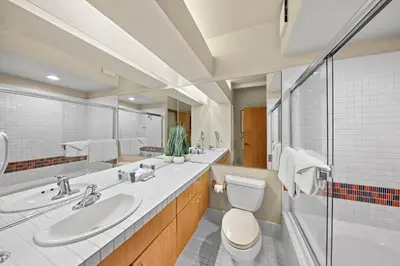 a bathroom with a sink and a toilet and a mirror at Palisades Tahoe Lodge Rentals Studio #217 in Olympic Valley