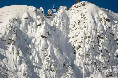 a mountain covered in snow with a ski lift at Palisades Tahoe Lodge Rentals Studio #217 in Olympic Valley