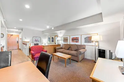 a living room with a couch and a table at Palisades Tahoe Lodge Rentals Studio #215 in Olympic Valley