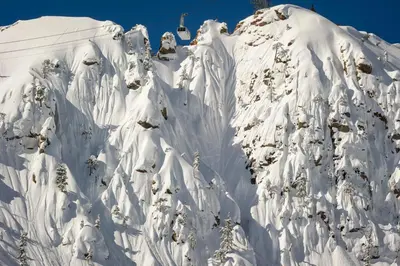 a mountain covered in snow with a ski lift at Palisades Tahoe Lodge Rentals Studio #226 in Olympic Valley
