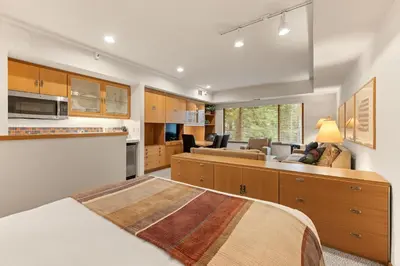 a kitchen and living room with a bed in a room at Palisades Tahoe Lodge Rentals Studio #228 in Olympic Valley