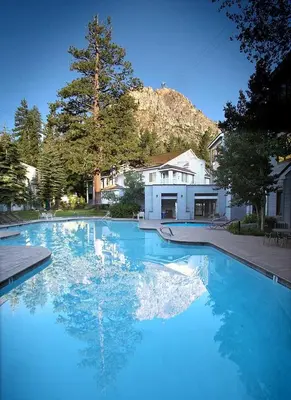 a large pool of blue water in a yard at Palisades Tahoe Lodge Rentals Studio #228 in Olympic Valley