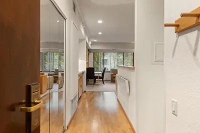a hallway with a kitchen and a dining room at Palisades Tahoe Lodge Rentals Studio #228 in Olympic Valley