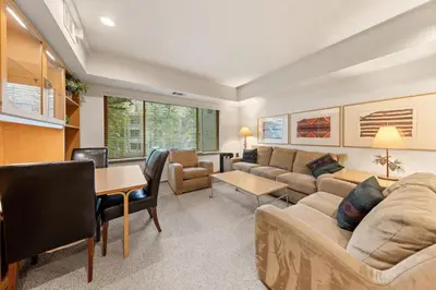 a living room with a couch and a table at Palisades Tahoe Lodge Rentals Studio #228 in Olympic Valley