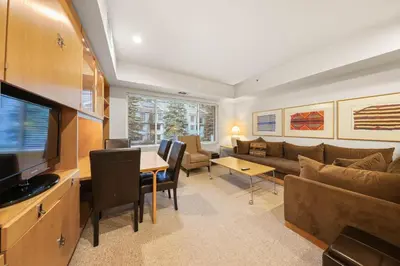 a living room with a couch and a table at Palisades Tahoe Lodge Rentals Studio #234 in Olympic Valley