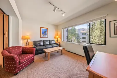 a living room with a couch and a chair at Palisades Tahoe Lodge Rentals Studio #246 in Olympic Valley