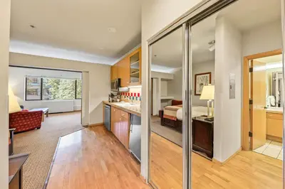 a room with a kitchen and a living room at Palisades Tahoe Lodge Rentals Studio #246 in Olympic Valley