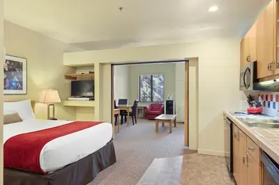 a hotel room with a bed and a kitchen at Palisades Tahoe Lodge Rentals Studio #250 in Olympic Valley