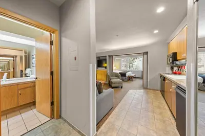 a kitchen and living room with a couch and a table at Palisades Tahoe Lodge Rentals Studio #255 in Olympic Valley