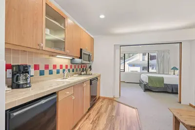a kitchen with a sink and a bed in a room at Palisades Tahoe Lodge Rentals Studio #254 in Olympic Valley