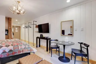 a bedroom with a bed and a table and a mirror at Slope Side Studio in Northstar Village! in Truckee
