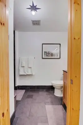 a bathroom with a toilet and a star on the wall at Slope Side Studio in Northstar Village! in Truckee