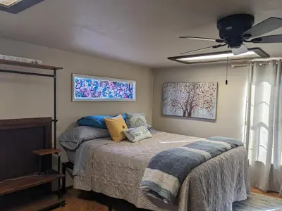 a bedroom with a bed and a ceiling fan at Rustic Rooms Barn Loft (Upstairs Studio Apartment) Near Kings Canyon & Sequoia National Parks in Squaw Valley