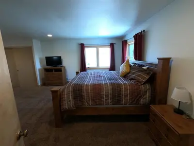 a bedroom with a bed and a window and a television at Rr-johnson Suite in June Lake