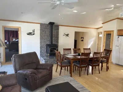 a living room with a table and chairs and a fireplace at Rr-johnson Suite in June Lake