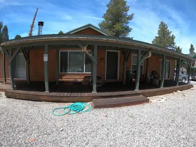 a house with around porch with a deck at Rr-kenton Hs in June Lake