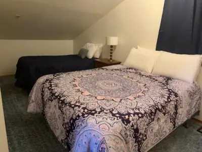 a bedroom with a bed with a blanket on it at Rr-june Lake Lodge in June Lake