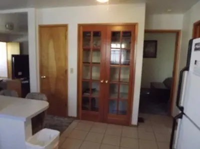 a kitchen with wooden cabinets and a refrigerator in a room at Rr-june Lake Lodge in June Lake