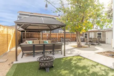 a patio with a table and an umbrella at Rustic 3-Bedroom, 1.5-Bath Oasis by Downtown in Reno