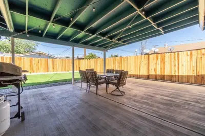 a patio with a table and chairs and a fence at Reno Serenade: 3-Bed Urban Sanctuary in Reno