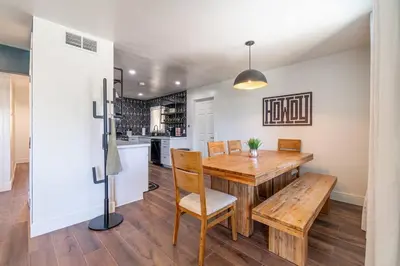 a kitchen and dining room with a wooden table and chairs at Reno Serenade: 3-Bed Urban Sanctuary in Reno