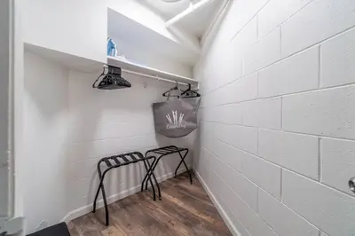 a hallway with two racks in a white brick wall at Stylish-Serene Midtown Getaway: Retreat for Two in Reno