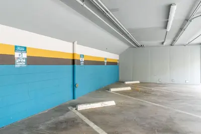 an empty parking garage with blue and yellow walls at Stylish-Serene Midtown Getaway: Retreat for Two in Reno