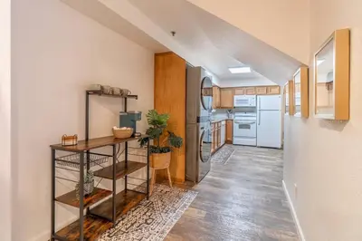 a kitchen with wooden floors and white appliances at Stylish-Serene Midtown Getaway: Retreat for Two in Reno
