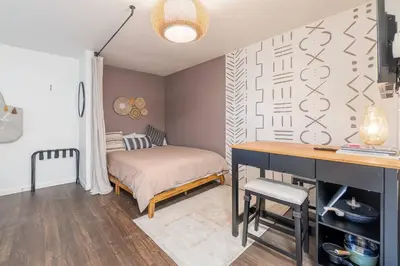 a bedroom with a bed and a desk in it at Midtown Getaway: Trendy Studio Heart of Reno in Reno