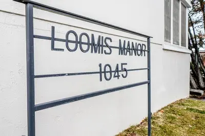 a sign in front of a white building at Riverside Glam: Stylish Urban Escape in Reno