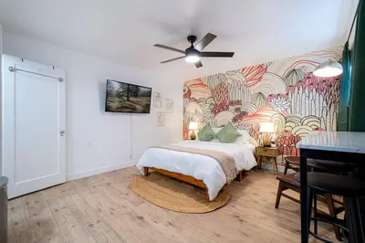 a bedroom with a bed and a painting on the wall at Riverside Glam: Stylish Urban Escape in Reno