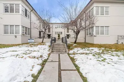 a building with snow in front of a building at Riverside Glam: Stylish Urban Escape in Reno