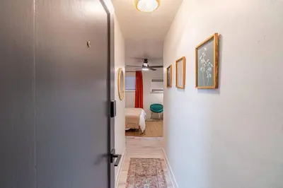 a hallway with a door leading to a bedroom at Riverside Luxe: Stylish Designer Retreat in Reno