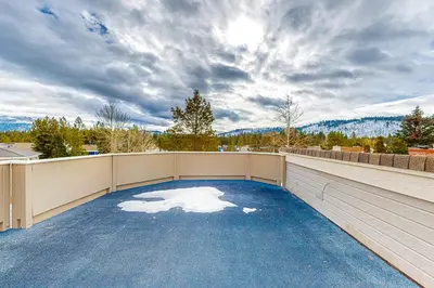 an outdoor patio with blue carpeting on a balcony at Rooftop Retreat in South Lake Tahoe