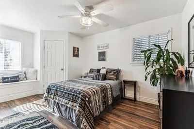 a bedroom with a bed and a ceiling fan at ¤ Old Folsom La Boheme Artist Retreat + Jacuzzi ¤ in Folsom