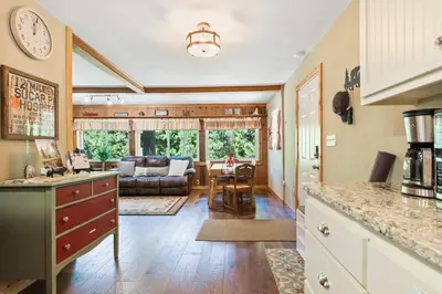 a large kitchen and living room with a couch at Lewis Creek cabin near Yosemite king beds in Oakhurst