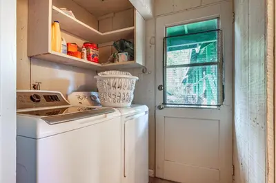 a kitchen with a washing machine and a window at Cozy Mi-Wuk Village Cabin 18 Mi to Dodge Ridge! in Mi-Wuk Village
