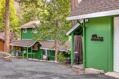 a green building with a horse sign on it at Cozy Mi-Wuk Village Cabin 18 Mi to Dodge Ridge! in Mi-Wuk Village
