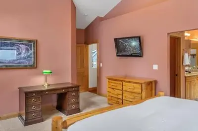 a bedroom with a bed and a desk and a mirror at Family Friendly 3BD-Next to Beach & Ski Resort in Kings Beach