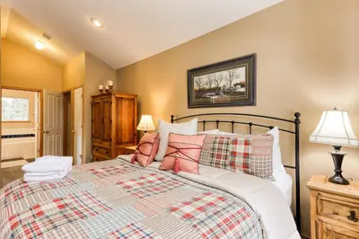 a bedroom with a large bed and two lamps at Gentian Family Retreat in South Lake Tahoe